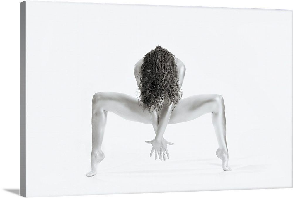 High key black and white portrait of a nude woman balancing and creating shapes with her body.