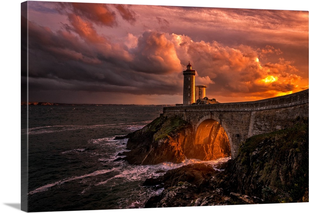 Vibrant sunset light over a lighthouse on the French coast.