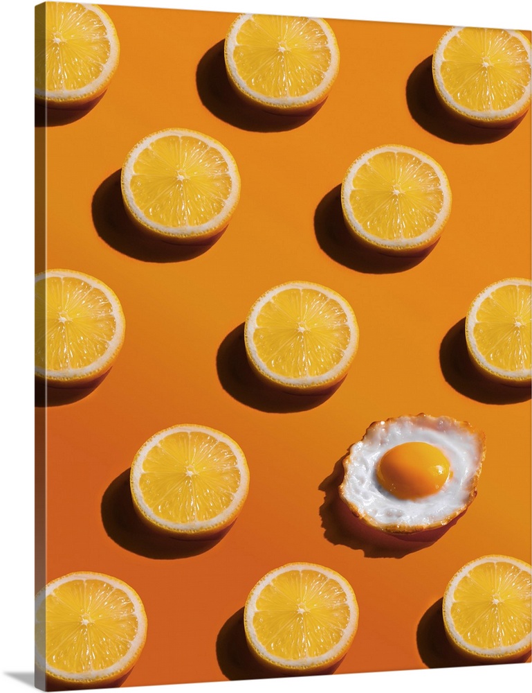 Lemon slices pattern with a fried egg, yellow background, abstract, surprise concept.