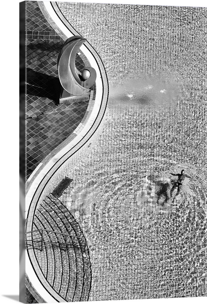 Aerial view of a person swimming in a large pool.
