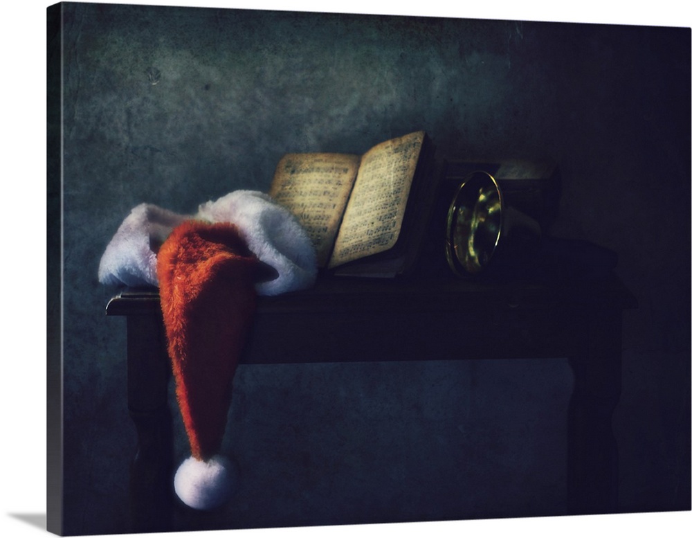 A shelf with a Santa hat, a music book, and a horn in soft light.