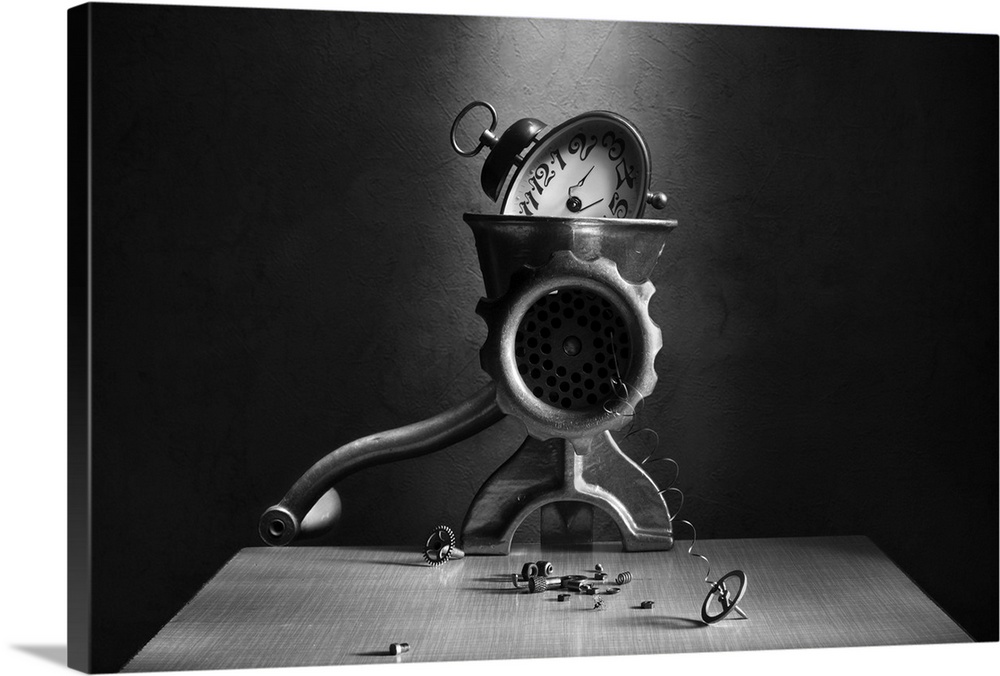 An alarm clock in a meat grinder, with springs and gears coming out.