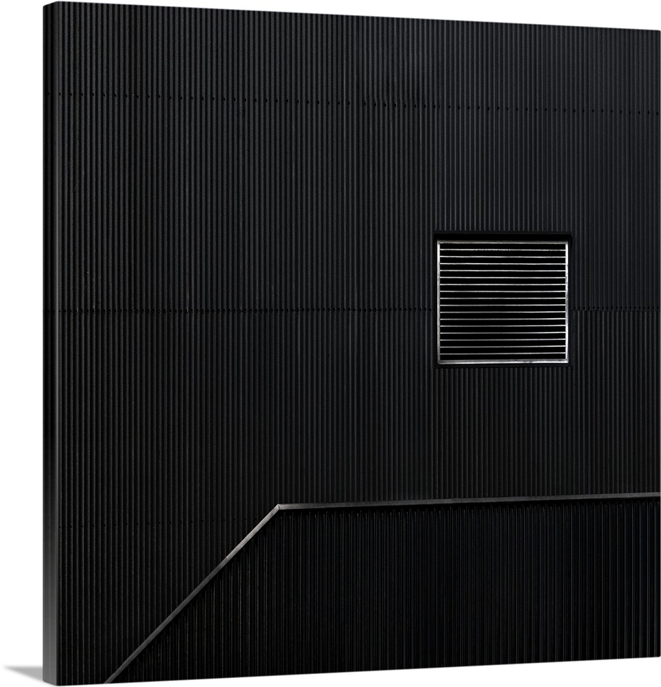 A ventilation grate's vertical lines contrast with the horizontal corrugation on the side of a building.