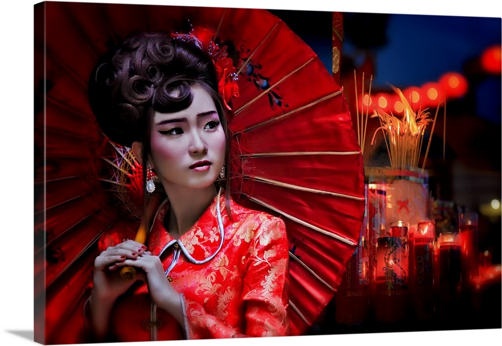 A young woman wearing a traditional Chinese outfit and holding a red parasol.