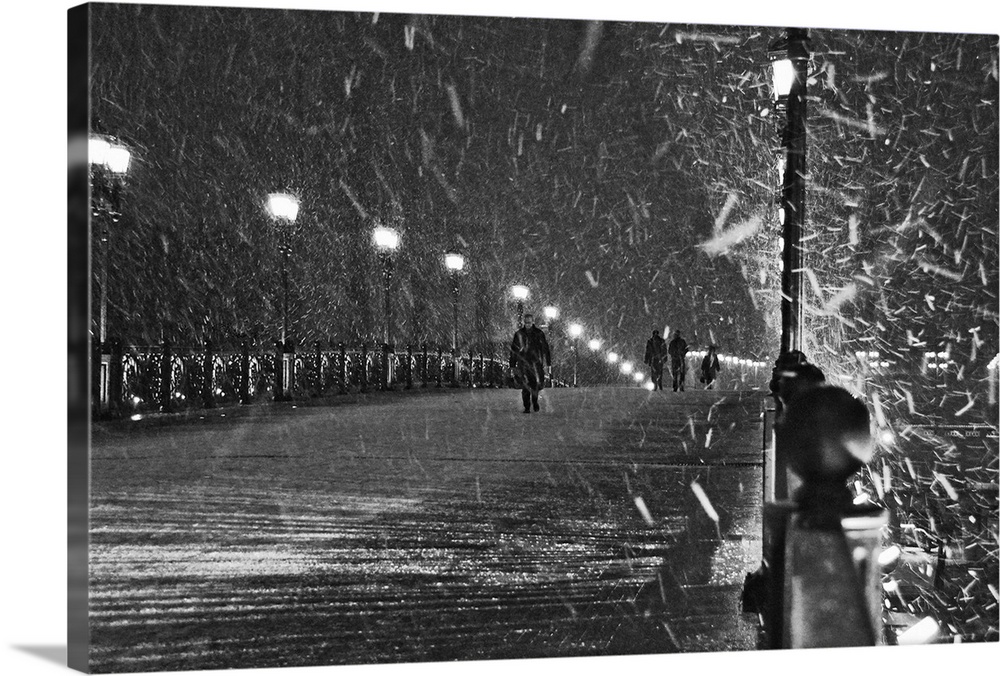 People walking over a bridge in Moscow, Russia, during a snowstorm.
