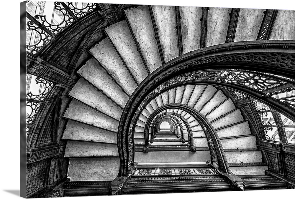 Black and white abstract photograph of a winding staircase.