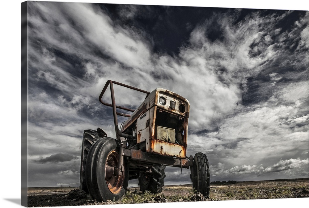 A derelict farming tractor in a desolate field, Iceland.