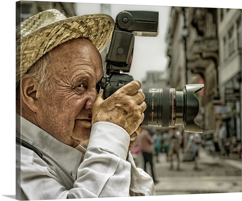 Portrait of an elderly man taking a photo with a large camera, Budapest, Hungary.