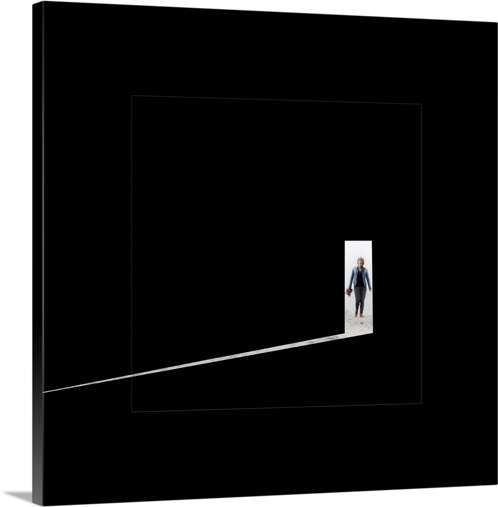 Person in a doorway entering a completely dark room, with a shaft of light beaming in.