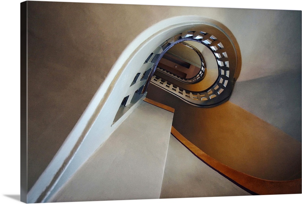 View of a curving staircase in a building, creating an abstract image.