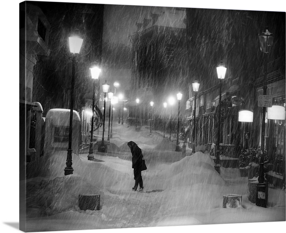 Heavy snowfall in the streets of Paris at night.