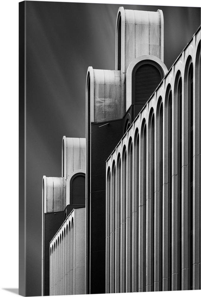 Black and white image of the facade of a a structure, creating an abstract image.