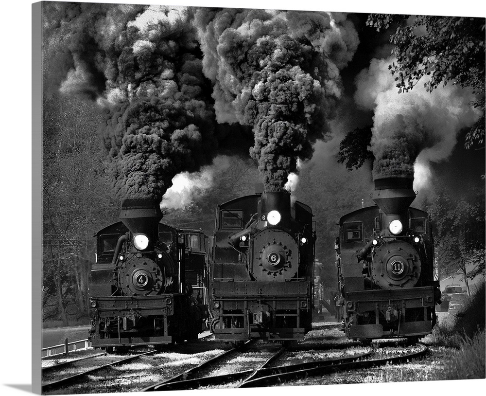 Three steam locomotives chugging along the tracks.