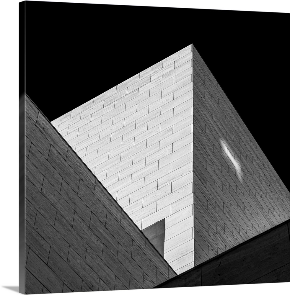 Black and white image of triangular shadows created by a modern building.