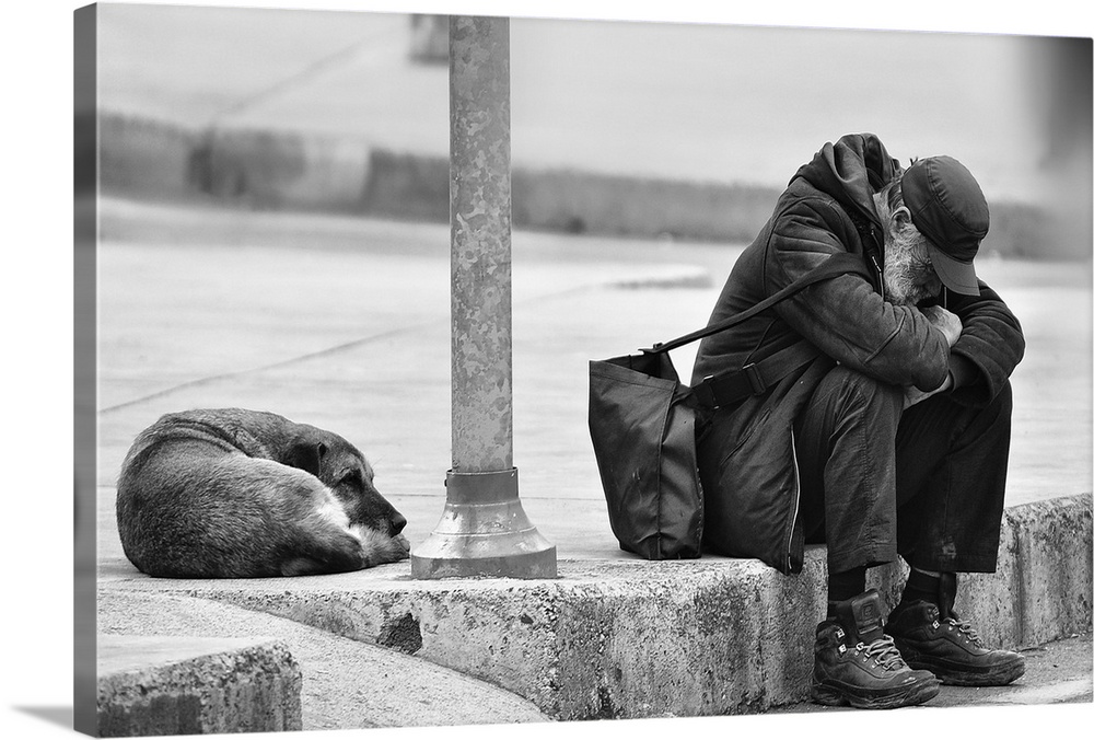 A homeless man and a dog sit together sadly on a curb.