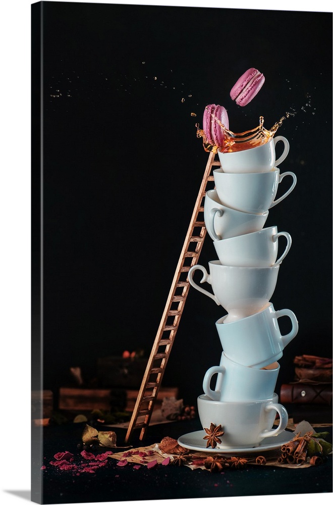 Tower of white coffee cups with a ladder, macaroons, splash and coffee drops on a dark background. Indulgence concept. Act...