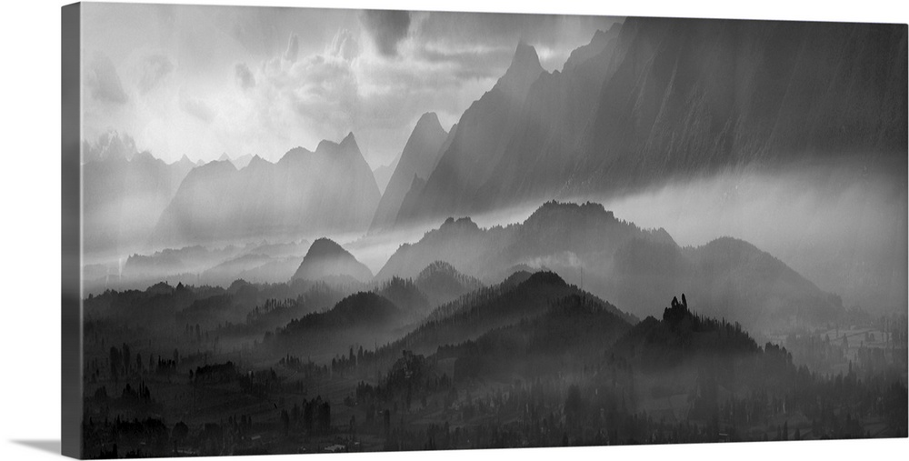 Black and white image of a misty mountain landscape.