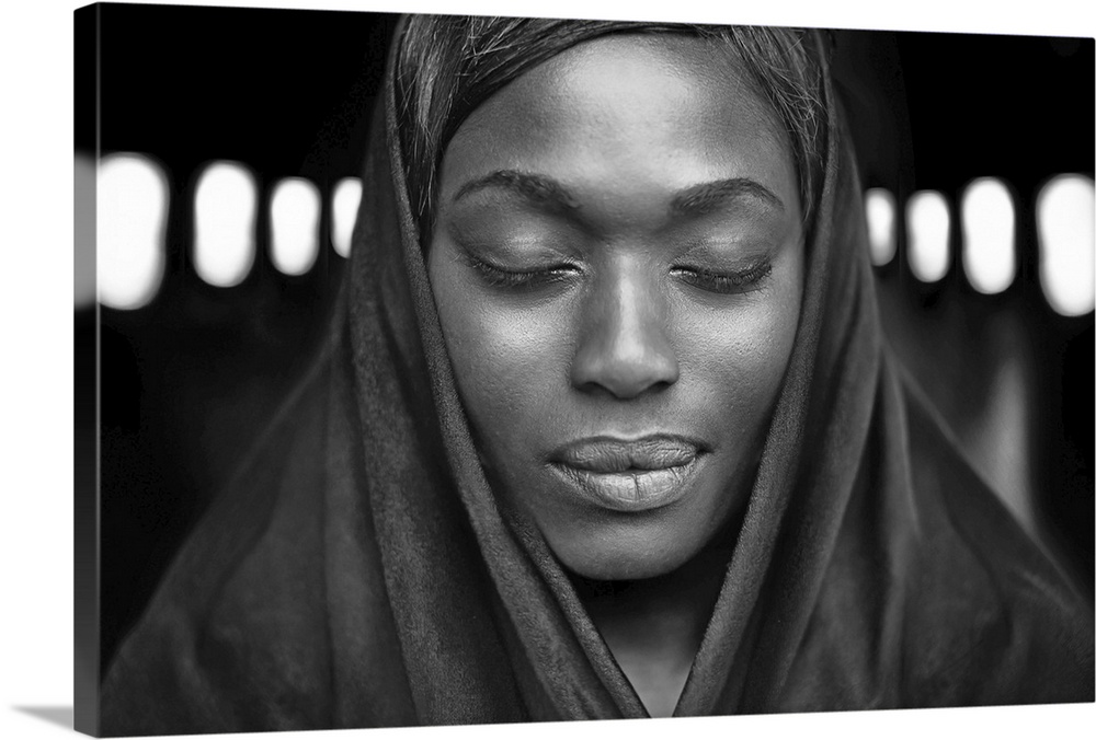 Black and white portrait of a beautiful dark-skinned woman with eyes closed.