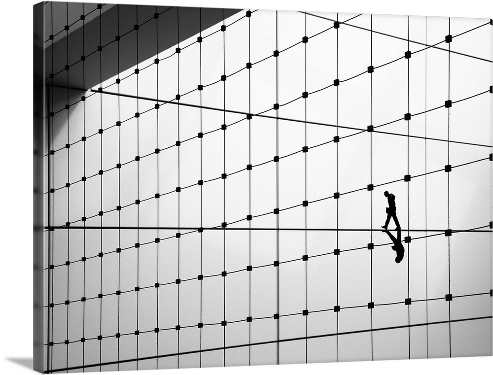 Conceptual image of a person walking on a thin line, one of many on the side of a building.