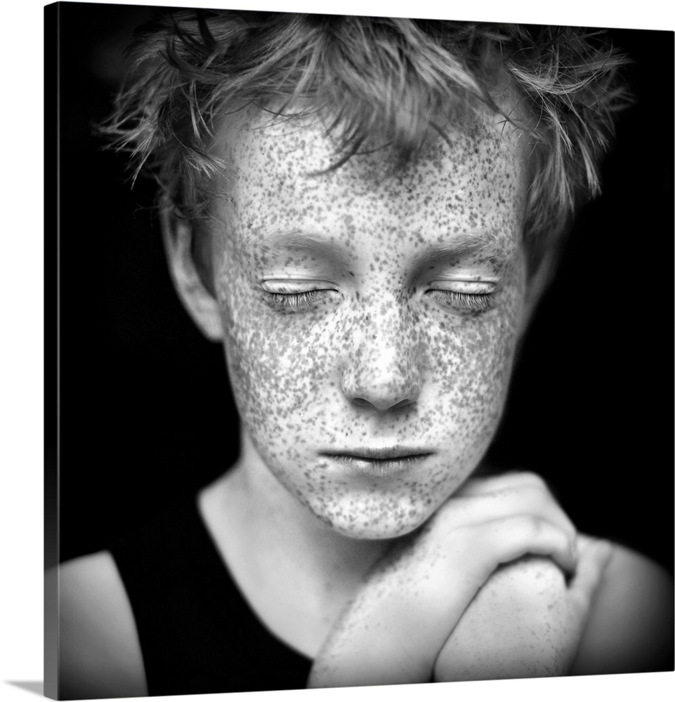 Black and white portrait of a young boy with freckles.