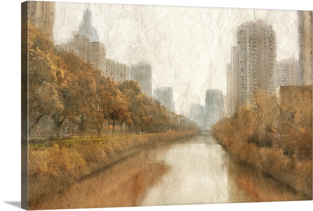 Fall scene of a river in a city with skyscrapers and orange trees.