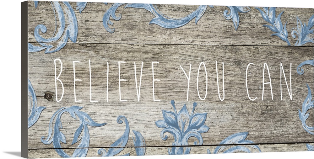 "Believe you can" in thin letters on a wooden plank with blue florals.