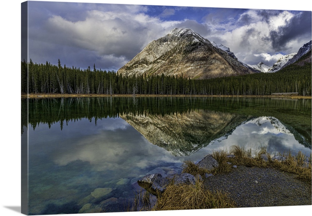 Panoramic reflections at Buller Pond. Snow-capped Buller Mountain in the distance. Alberta, Canada.