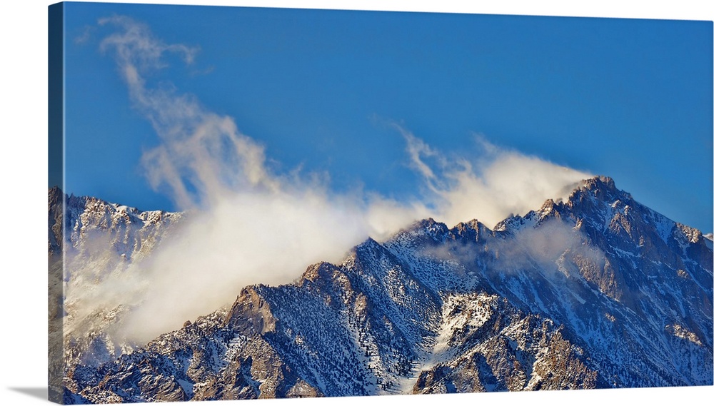 Off the top - High winds blow snow off the mountaintops in California's Eastern Sierras.