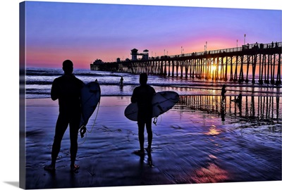 Surfers at sunset near the iconic Oceanside Pier