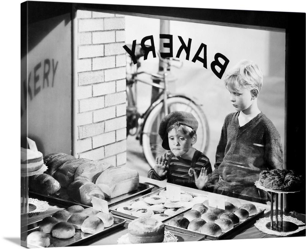 1930s 1940s two boys looking in bakery shop window at desserts. One boy pressing hands and nose against window.