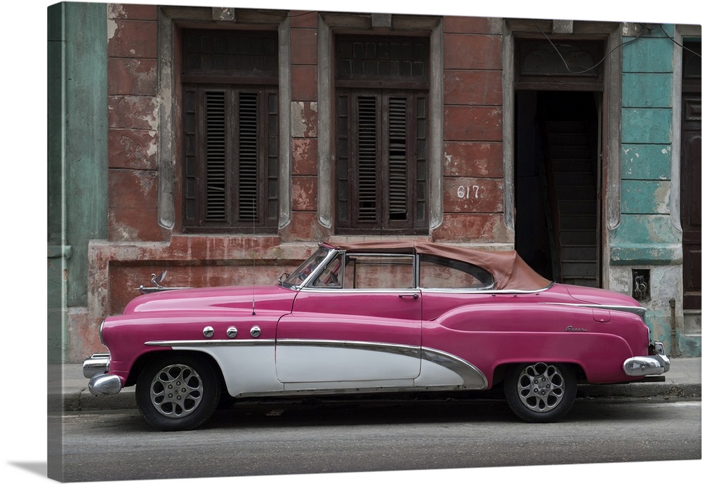 1950s classic American pink car set against a traditional Cuban house.