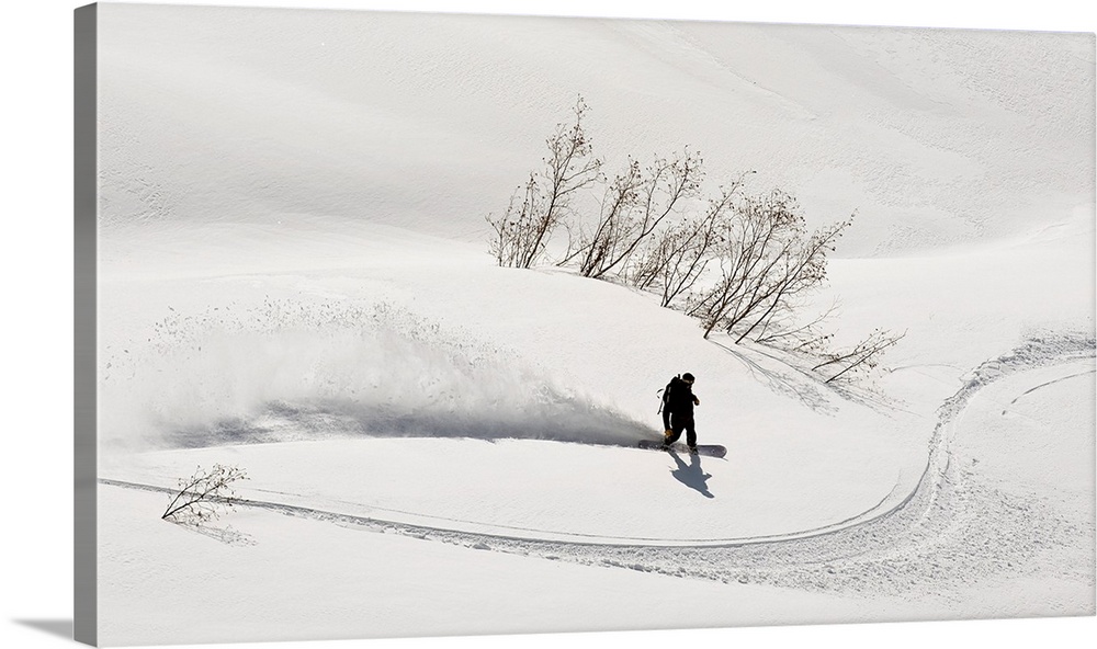 A Backcountry Snowboarder Carving In Turnagain Pass, Alaska