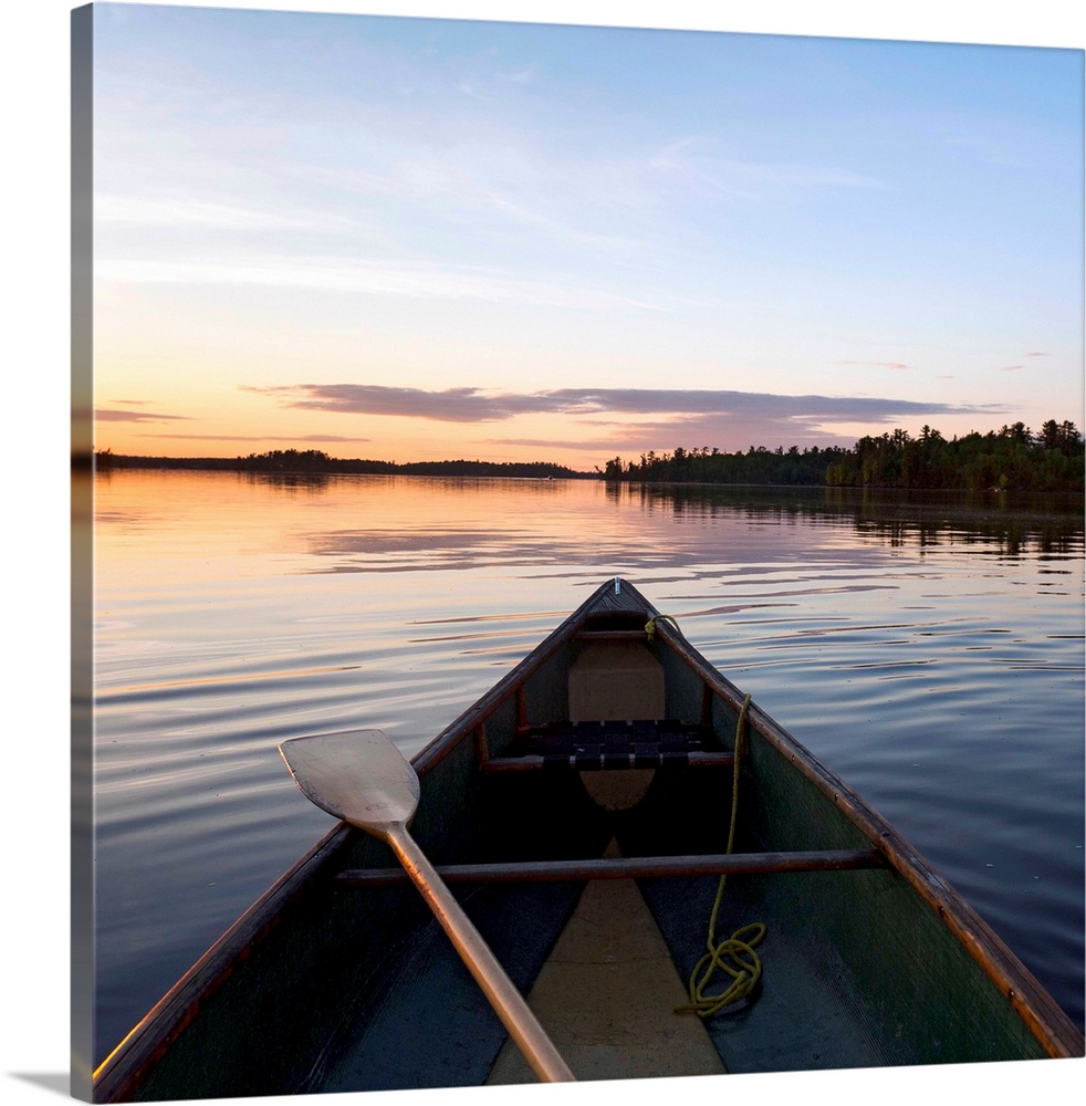 A Boat And Paddle On A Tranquil Lake At Sunset, Ontario, Canada