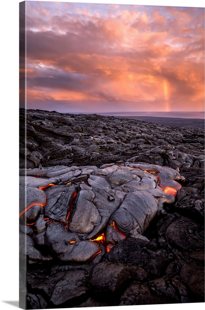 A cooling lava flow on Kilauea, and distant rainbow over the water.