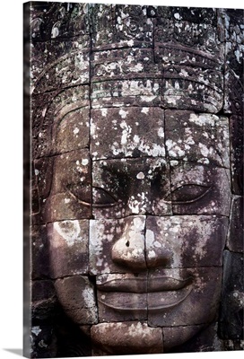 A face sculpture on a stone wall at angkor wat, Cambodia