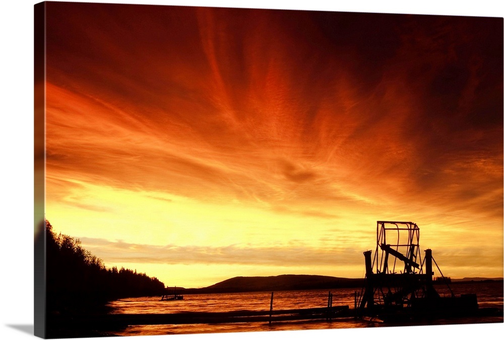 A fish wheel spins during sunrise on the Tanana River near the village