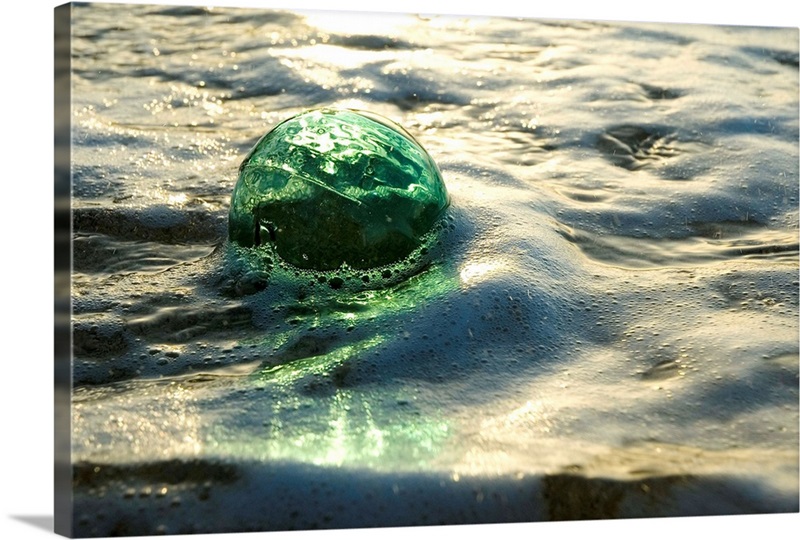 A Glass Fishing Ball Floats in Shallow Water | Large Metal Wall Art Print | Great Big Canvas