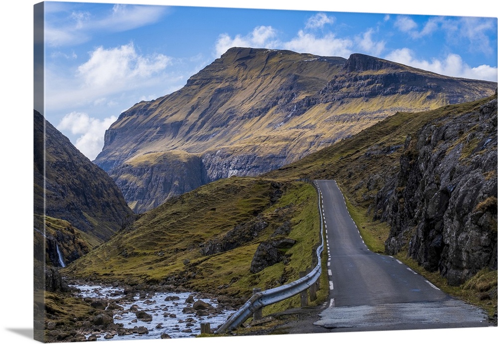 A scenic empty straight uphill road leading to Saksun on the Faroe Islands.