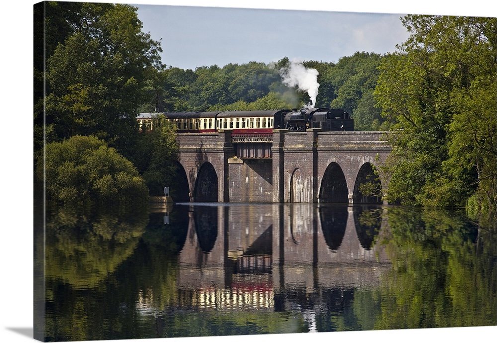 A steam train on Swithind Reservoir Viaduct which is part of the Great Central Railway in Leicestershire.