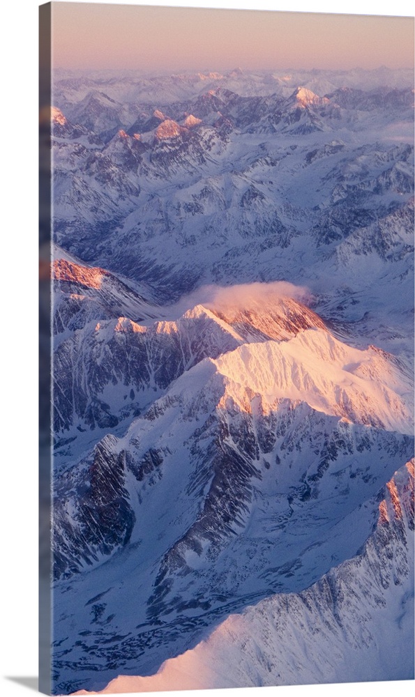 Aerial view of the Chugach Mountain range with sunrise alpenglow hitting the peaks during Winter in Southcentral Alaska