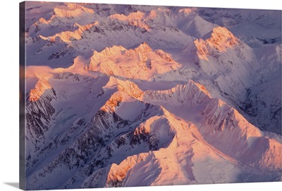 Aerial view of the Chugach Mountain range with sunrise alpenglow hitting the peaks