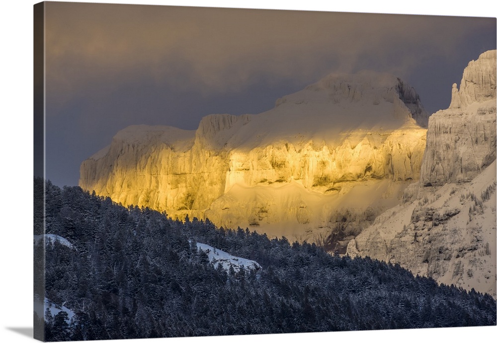 Coated with snow and illuminated with the warm light of sunset, Amphitheater Mountain glows with a wonderful golden color ...