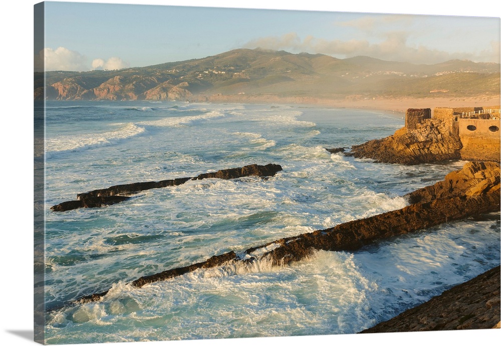 Atlantic Ocean waves along the shores of the Praia do Guincho near Cascais with the Estalagem Muchaox hotel's outdoor swim...
