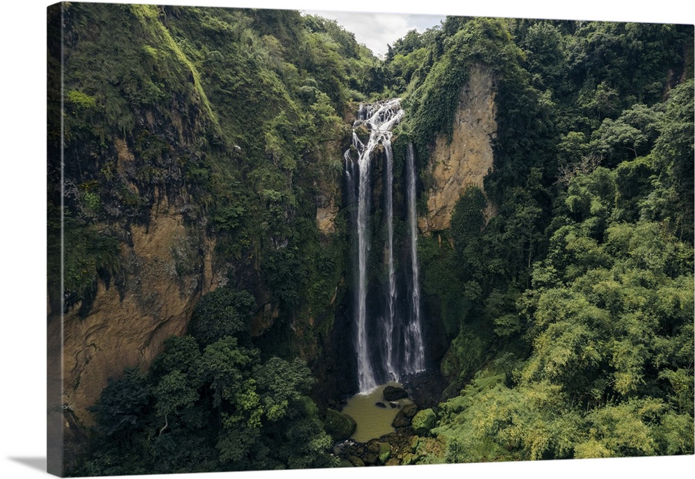 Beautiful waterfalls falling from a lush cliff at air Terjun Bossolo, south Sulawesi, Indonesia. Jeneponto regency, south ...