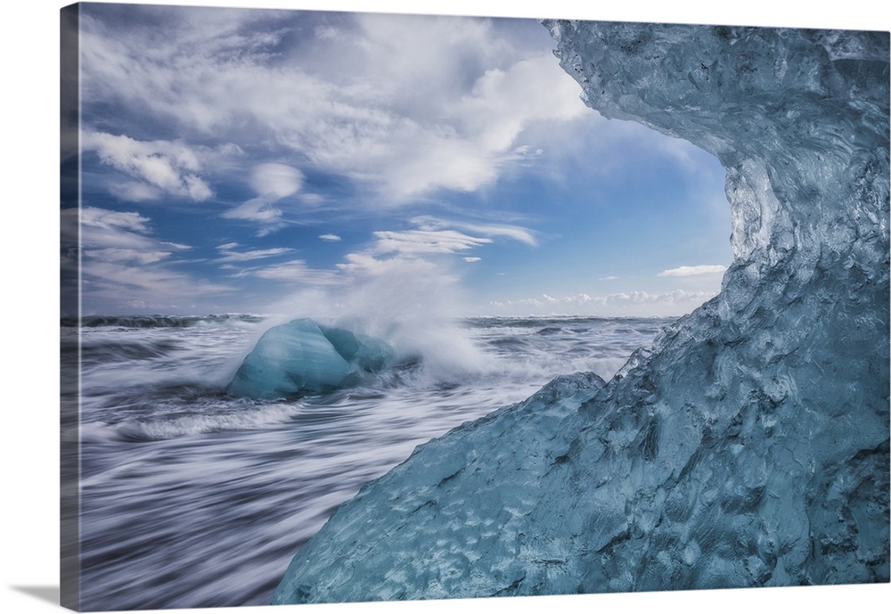 Blue ice and icebergs with water splashing at Jokulsarlon, South coast; Iceland