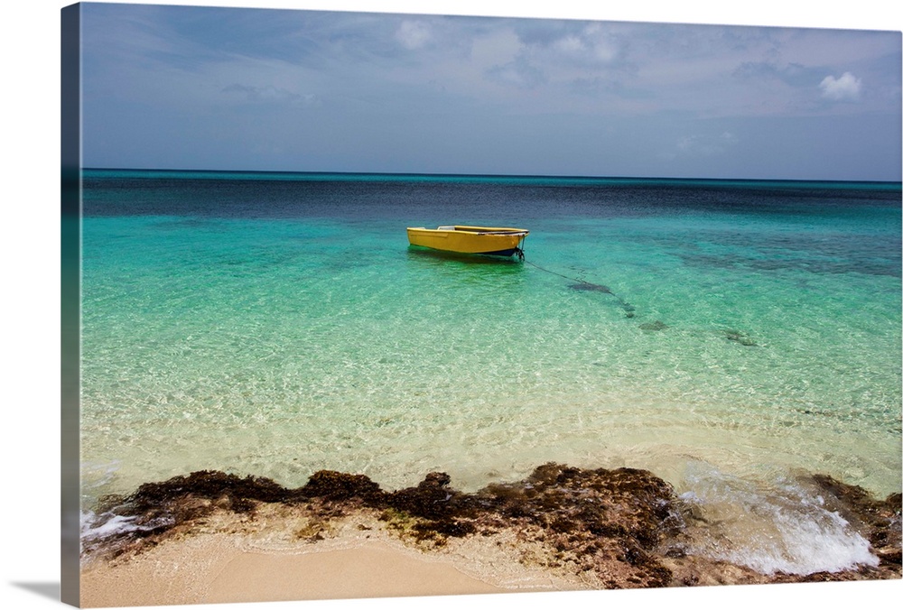 A lone boat in the turquoise water off a tropical island, Frederiksted, St. Croix, Virgin Islands, United States of America.
