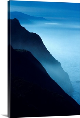 California, Big Sur Coast, Silhouetted Cliffs Along Foggy Ocean Shoreline