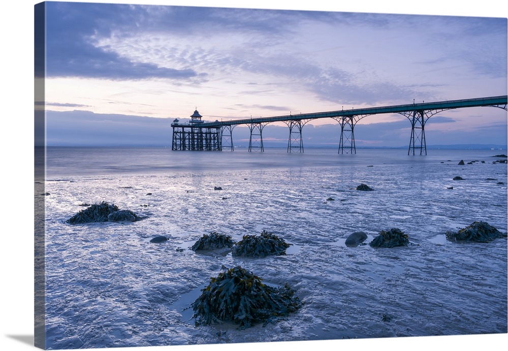 Clevedon Pier in the Severn Estuary at low tide after sunset.