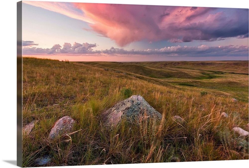 Clouds Lit At Sunset With Some Glacial Erratics Lying In Grasslands National Park;Saskatchewan Canada