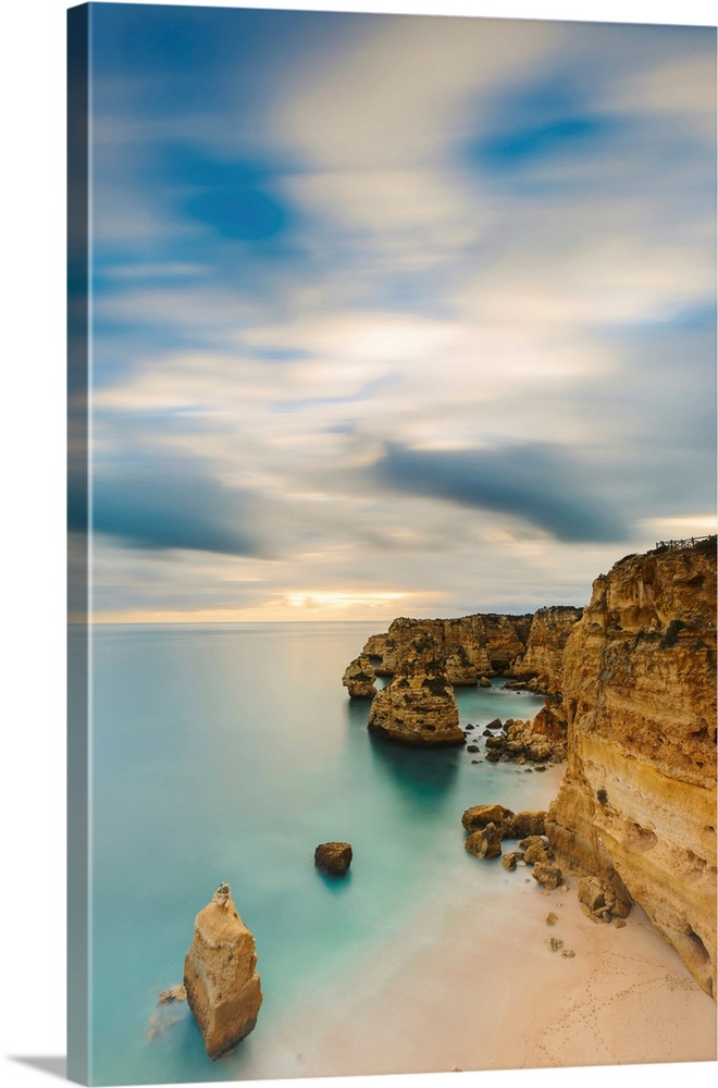 Coastal rock formations and turquoise water of the Atlantic Ocean along the rugged coast of the Algarve Region, Algarve, P...